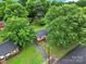 Aerial view of the home, showing mature trees, a well-maintained yard, and neighborhood setting at 7412 Woodstream Dr, Charlotte, NC 28210