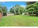 Expansive backyard featuring a detached garage and lush greenery, perfect for outdoor activities at 7412 Woodstream Dr, Charlotte, NC 28210