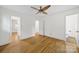 Spacious bedroom with hardwood floors, neutral walls, ceiling fan and two doorways, offering great flow and access at 7412 Woodstream Dr, Charlotte, NC 28210