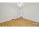 Simple bedroom featuring hardwood floors, neutral paint, and a closet at 7412 Woodstream Dr, Charlotte, NC 28210