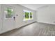 Open dining area featuring vinyl floors, a bay window, and an exterior door at 7412 Woodstream Dr, Charlotte, NC 28210