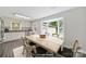 Bright dining area with wood floors, bay window, and adjacent updated kitchen at 7412 Woodstream Dr, Charlotte, NC 28210