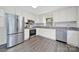 Modern kitchen with stainless steel appliances, white cabinets, and granite countertops at 7412 Woodstream Dr, Charlotte, NC 28210