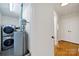 Functional laundry room with washer, dryer, and water heater; conveniently located in the house at 7412 Woodstream Dr, Charlotte, NC 28210