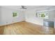 Bright, airy living room featuring hardwood floors, neutral paint, and a contemporary ceiling fan at 7412 Woodstream Dr, Charlotte, NC 28210