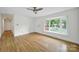 Sunlit living room with hardwood floors, large bay window, and neutral paint scheme at 7412 Woodstream Dr, Charlotte, NC 28210