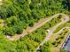 An aerial view shows a winding walking path through lush greenery, offering a serene outdoor experience at 83 Woodsdale Se Pl, Concord, NC 28025