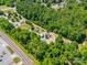 The aerial view shows a community park surrounded by lush greenery and walking paths at 83 Woodsdale Se Pl, Concord, NC 28025