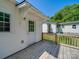 The property features a wooden back porch and white siding at 83 Woodsdale Se Pl, Concord, NC 28025