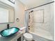 Bathroom boasts a unique vessel sink, modern fixtures, and shower with stylish tiling at 83 Woodsdale Se Pl, Concord, NC 28025