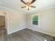 This bedroom has a ceiling fan, window and light colored walls and floors at 83 Woodsdale Se Pl, Concord, NC 28025