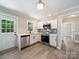 Bright kitchen features stainless steel appliances, white cabinetry, and ample natural light at 83 Woodsdale Se Pl, Concord, NC 28025