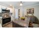 Modern kitchen featuring stainless steel appliances, an island, and stylish cabinetry with contemporary decor at 83 Woodsdale Se Pl, Concord, NC 28025