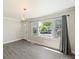 Bright living room featuring a large window with street views, modern lighting, and neutral wall colors at 83 Woodsdale Se Pl, Concord, NC 28025