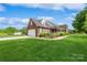 Spacious home with a brick exterior, a fountain, and a large, green lawn at 8520 Wright Rd, Kannapolis, NC 28081