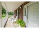 Charming front porch with white rocking chairs and a brick exterior at 8520 Wright Rd, Kannapolis, NC 28081