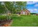 Charming brick home with a well-manicured lawn and lush landscaping at 8520 Wright Rd, Kannapolis, NC 28081