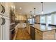 Well-equipped kitchen featuring granite countertops, stainless steel appliances, and custom cabinetry at 8520 Wright Rd, Kannapolis, NC 28081