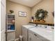 Organized laundry room with shelving, decor, washer and dryer with folding shelf at 8520 Wright Rd, Kannapolis, NC 28081