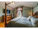 Vaulted main bedroom with window, hardwood floor, ceiling fan, TV, and decor at 8520 Wright Rd, Kannapolis, NC 28081