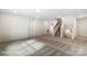 Large, open basement with carpet, stairs, and multiple entryways at 8619 Frank Grier Rd # 3, Charlotte, NC 28215