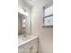 Bathroom featuring a single sink vanity with modern fixtures, large mirror, and natural light at 8619 Frank Grier Rd # 3, Charlotte, NC 28215