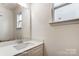 Bathroom featuring a single sink vanity with modern fixtures and a large mirror at 8619 Frank Grier Rd # 3, Charlotte, NC 28215