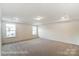 Large bedroom with carpet and tray ceiling at 8619 Frank Grier Rd # 3, Charlotte, NC 28215