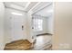Bright foyer with hardwood floors, white trim and paint, and a view into the home's interior at 8619 Frank Grier Rd # 3, Charlotte, NC 28215