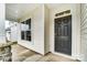 An inviting front entrance with a black door, stone accents, and a covered porch at 8619 Frank Grier Rd # 3, Charlotte, NC 28215