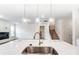 Modern kitchen features a large island with pendant lighting and stainless steel faucet at 8619 Frank Grier Rd # 3, Charlotte, NC 28215
