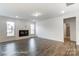 Spacious living room with dark hardwood floors, a cozy fireplace, and plenty of natural light at 8619 Frank Grier Rd # 3, Charlotte, NC 28215
