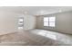 Spacious living room with carpet, a large window, and natural light at 8619 Frank Grier Rd # 3, Charlotte, NC 28215