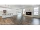 Open-concept living space showcasing a modern fireplace, and an adjacent kitchen area at 8619 Frank Grier Rd # 3, Charlotte, NC 28215