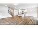 Open-concept living space featuring a staircase, kitchen with an island, and ample room for entertaining at 8619 Frank Grier Rd # 3, Charlotte, NC 28215