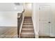Staircase with carpet, dark wood railing, and white trim at 8619 Frank Grier Rd # 3, Charlotte, NC 28215