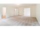Spacious living room featuring neutral carpeting and plenty of natural light at 8619 Frank Grier Rd # 3, Charlotte, NC 28215