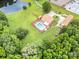 Aerial view of home with in-ground pool, spacious backyard, and wooded area at 907 Sikes Mill Rd, Monroe, NC 28110