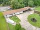 Aerial view of home featuring a long driveway, garage, and large front yard at 907 Sikes Mill Rd, Monroe, NC 28110