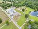 Aerial view of property with home, pond, garages, and road access at 907 Sikes Mill Rd, Monroe, NC 28110
