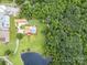 Aerial view of home with in-ground pool, wooded area, and pond at 907 Sikes Mill Rd, Monroe, NC 28110