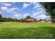 Expansive grassy backyard with a brick perimeter fence, offering privacy and space at 907 Sikes Mill Rd, Monroe, NC 28110