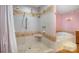 Bright bathroom showcasing a tiled walk-in shower and a soaking tub with a pink wall and trim at 907 Sikes Mill Rd, Monroe, NC 28110