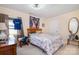 Comfortable bedroom with natural light, wooden bed frame and closet at 907 Sikes Mill Rd, Monroe, NC 28110