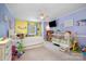 Colorful bedroom with playful decor, featuring a daybed, crib, and carpeted floors at 907 Sikes Mill Rd, Monroe, NC 28110