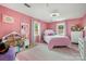 Pink bedroom with two windows, featuring carpeted floors, and a white bed with pink bedding at 907 Sikes Mill Rd, Monroe, NC 28110