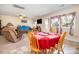 Bright dining area with a red tablecloth, seamlessly connected to the living space at 907 Sikes Mill Rd, Monroe, NC 28110
