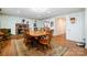 Dining room featuring a brick fireplace, wood flooring and table with seating at 907 Sikes Mill Rd, Monroe, NC 28110