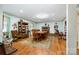 Bright dining room featuring hardwood floors, a large table, and a decorative brick fireplace at 907 Sikes Mill Rd, Monroe, NC 28110