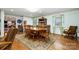 Bright dining room featuring a wood table, chairs, and hardwood flooring at 907 Sikes Mill Rd, Monroe, NC 28110